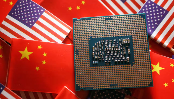 A central processing unit (CPU) semiconductor chip is displayed among the flags of China and the United States, in this illustrative photo taken February 17, 2023. — Reuters
