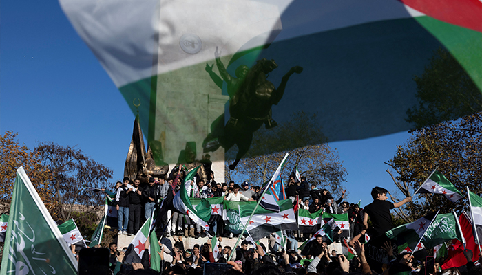 Syrians living in Turkey hold opposition flags as they celebrate after Syrian rebels announced that they have ousted Syrias Bashar al-Assad, in Istanbul, Turkey, December 8, 2024. — Reuters