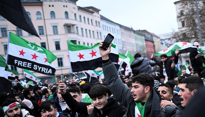 People wave Syrian flags, as they gather at Oranienplatz square, after Syrian rebels announced that they have ousted President Bashar al-Assad, in Berlin, Germany December 8, 2024. — Reuters