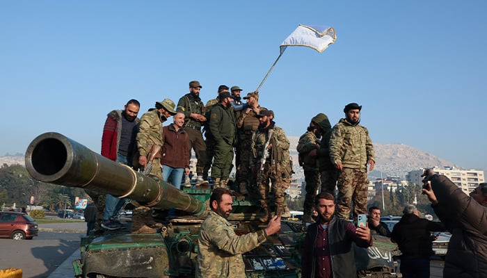 UN rights chief urges accountability in Syria, sees huge chance for fair transition 1 Rebel fighters stand on a tank, after rebels seized the capital and ousted President Bashar al-Assad, in Damascus, Syria, December 9, 2024. — Reuters
