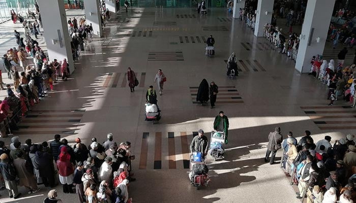 People gather to receive arriving passengers at the international arrival area of the Islamabad International Airport in Islamabad, Pakistan on February 3, 2020. — AFP