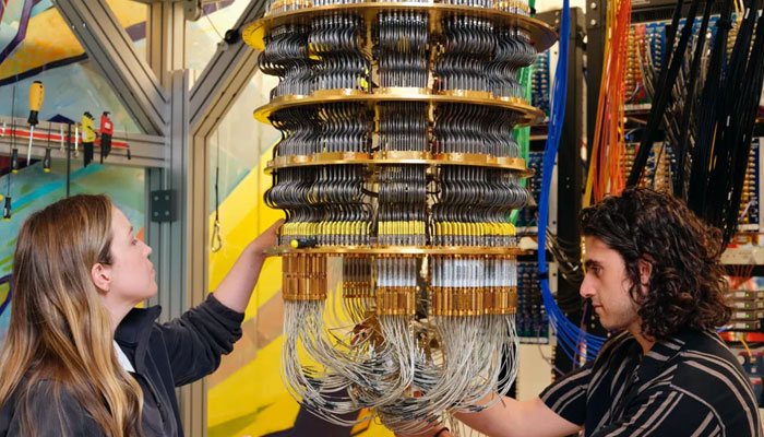 Google staff work on the cryostat that holds the chip and keeps it very cold.— Google/File