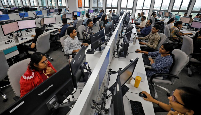 A representational image of Indian employees work on their terminals inside the office of Manubhai and Shah LLP in Ahmedabad, India, July 4, 2023. — Reuters