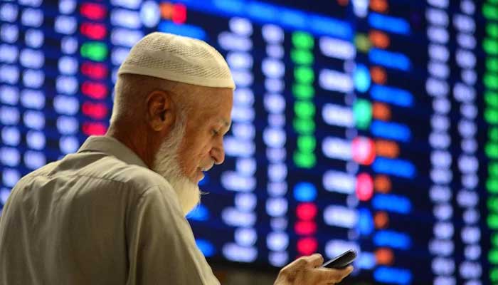 A Pakistani broker monitors stock prices during a trading session at PSX in Karachi, October 17, 2024. — INP