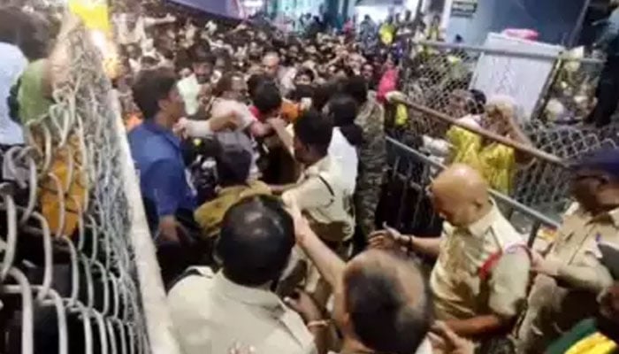 Indian police personnel try to manage the crowd at the Sri Venkateswara Swamy Temple in Andhra Pradesh, India. — ANI