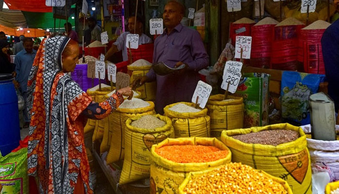A customer buys rice at a wholesale store in Karachi, June 8, 2023. — AFP