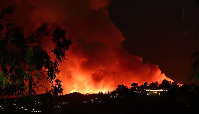 Smoke and flames from the Palisades Fire burn toward the Encino neighborhood of Los Angeles, California, January 10, 2025, triggering new evacuation orders. — AFP