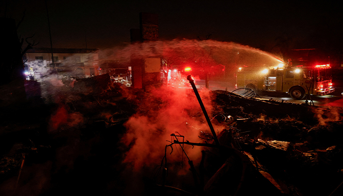 Firefighters hose down a hotspot at a commercial building that burned down during the Eaton Fire, in Altadena, California, US, January 10, 2025. — Reuters