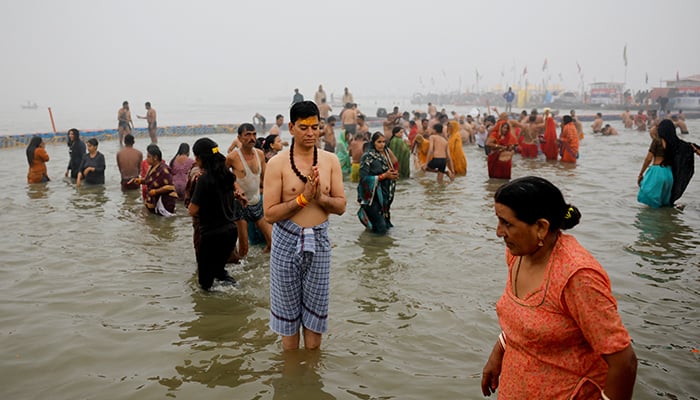 A devotee prays as he takes a holy dip at Sangam, the confluence of the Ganges, Yamuna and Saraswati rivers, during the Maha Kumbh Mela, or the Great Pitcher Festival, in Prayagraj, India, January 13, 2025. — Reuters