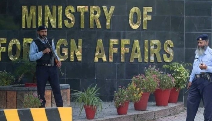 Security guards stand outside the Ministry of Foreign Affairs in Islamabad. — AFP