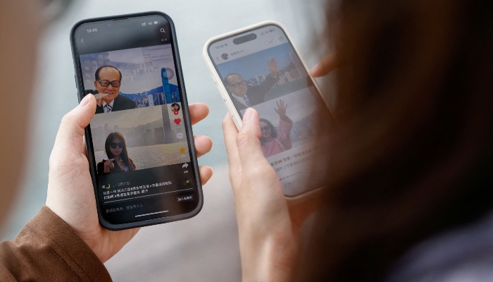 Laura Li, 28, and her cousin Diego Deng, 20, search on the Chinese social media platform Xiaohongshu in Hong Kong, China, on April 30, 2024. — Reuters