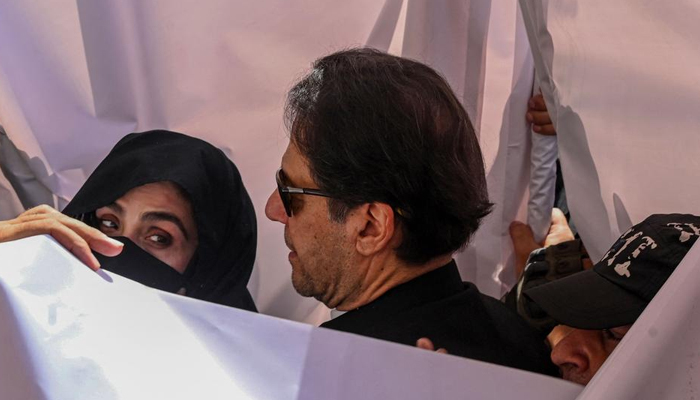 Former prime minister Imran Khan and his wife Bushra Bibi arrive to appear at Lahore High Court. — AFP/File