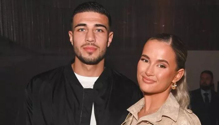 The couple is smiling for a picture
