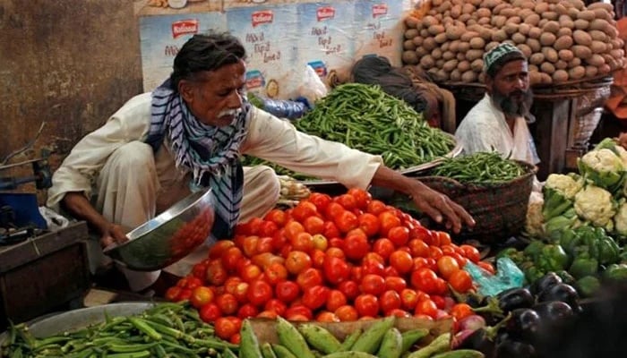 Men sell vegetables at their makeshift stalls at Empress Market in Karachi, April 2, 2018. — Reuters