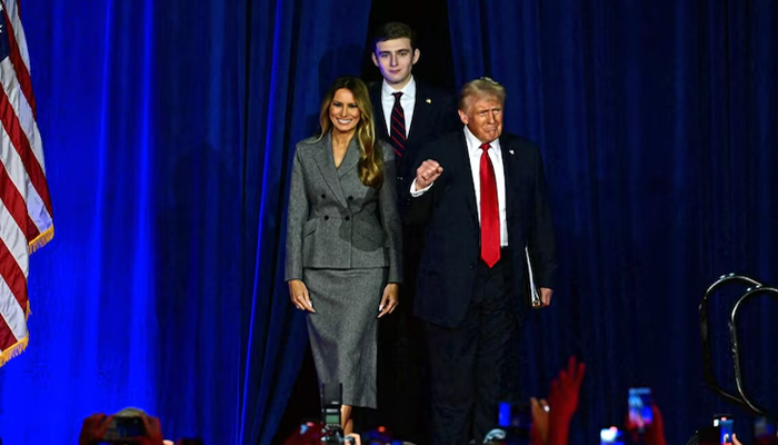 Barron Trump walks behind his parents Donald Trump and Melania Trump. — AFP/File