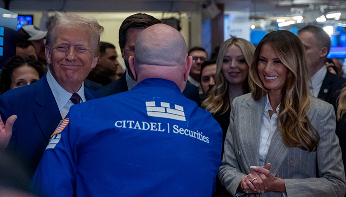 President-elect Donald Trump walks onto the floor of the New York Stock Exchange (NYSE) with his wife Melania, after being named TIMEs Person of the Year for the second time on December 12, 2024 in New York City. — AFP