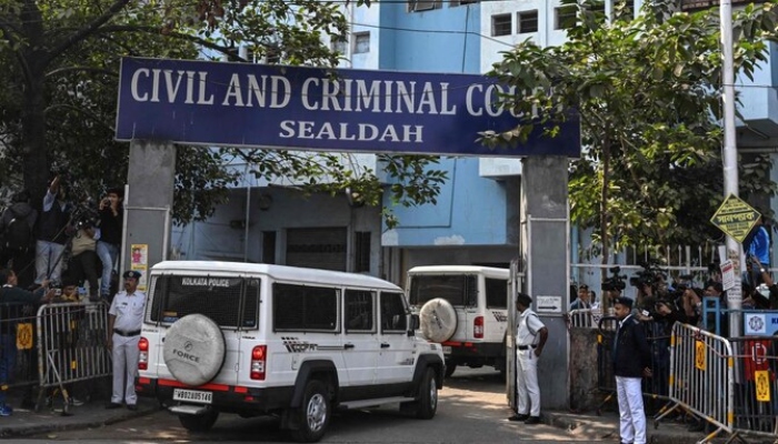 Police personnel stand guard at the entrance of the Civil and Criminal Court Sealdah as the main accused of the rape and murder of an Indian doctor arrives in Kolkata on January 18, 2025. — AFP