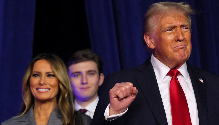 Donald Trump (R) takes the stage with his wife Melania Trump and son Barron Trump to address supporters at his rally, at the Palm Beach County Convention Center in West Palm Beach, Florida, on November 6. — Reuters