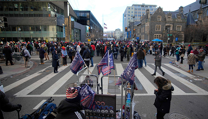 Vendors and supporters wait outside Capital One Arena ahead of the inauguration of US President-elect Donald Trump on January 20, 2025 in Washington, DC. — AFP