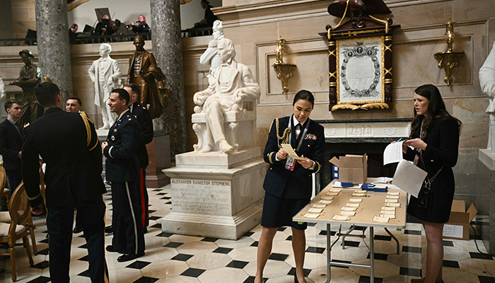 Workers organize name tages for a luncheon in Statuary Hall that will follow the inauguration ceremony where Donald Trump will sworn in as the 47th US President in the US Capitol Rotunda in Washington, DC, on January 20, 2025. — AFP