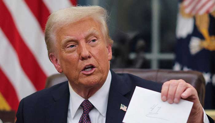 US President Donald Trump holds up a letter from former President Joe Biden as he issues executive orders and pardons for January 6 defendants in the Oval Office at the White House on inauguration day in Washington, US, January 20, 2025. — Reuters