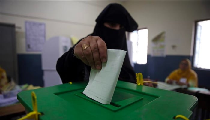 A voter casts her vote at a polling station during the general election in Islamabad, Pakistan, July 25, 2018. — Reuters