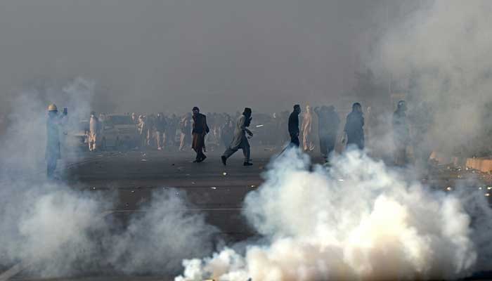 Police draw shells of tear gas to disperse the PTI supporters during a demonstration in Islamabad, November 26. - AFP