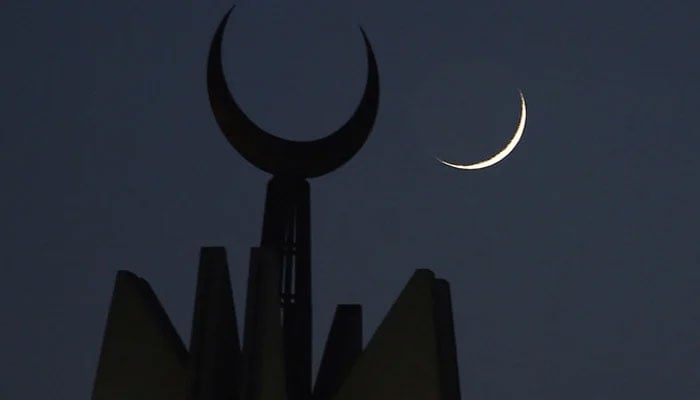 A representational image showing the moon rising over the giant Faisal Mosque in Islamabad. — AFP/File