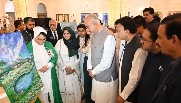Pakistans Ambassador to UAE Faisal Niaz Tirmizi views artworks during an exhibition to celebrate Pakistan Day. — Reporter