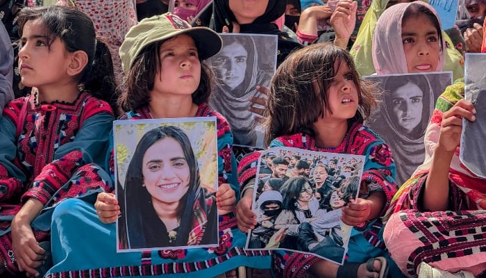 Children hold images of Baloch Yakjehti Committee (BYC) leader Mahrang Baloch during a protest in Panjgur. — X/@BalochYakjehtiC