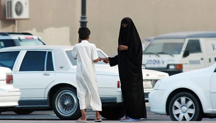 Representative image shows a woman and a boy beg for money at a street in the Saudi city of Dammam. — AFP/File