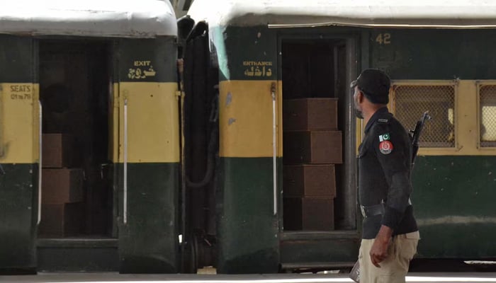 A security force personnel member stands guard near a train in Quetta, March 12, 2025. — Reuters