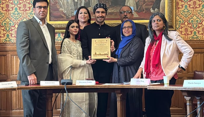 Multi-talented Pakistani cinema artist Feroze Khan (centre) receives the award. — Reporter