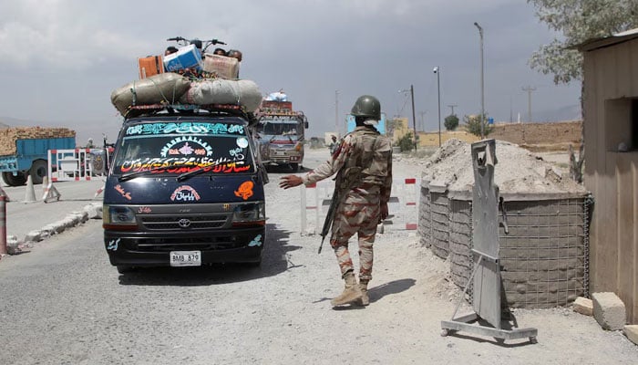 A paramilitary soldier stops and checks passenger vehicles at a security check post on the outskirts of Quetta.  — Reuters/File