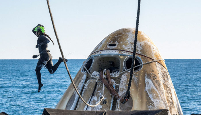 Support teams work around a SpaceX Dragon spacecraft shortly after it landed with Nasa astronauts Nick Hague, Suni Williams, Butch Wilmore, and Roscosmos cosmonaut Aleksandr Gorbunov aboard in the waters off the coast of Tallahassee, Florida, Tuesday, March 18, 2025. — Reuters
