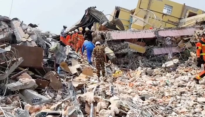 Specialists, including members of Russias emergencies ministry, take part in a search operation following a massive earthquake in Mandalay, Myanmar, in this still image from video released April 1, 2025.