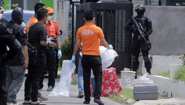 Indonesian anti-terror police and an identification team are seen outside a building during a raid in Batam, Riau Islands, Indonesia, August 5, 2016 in this photo taken by Antara Foto. — Reuters