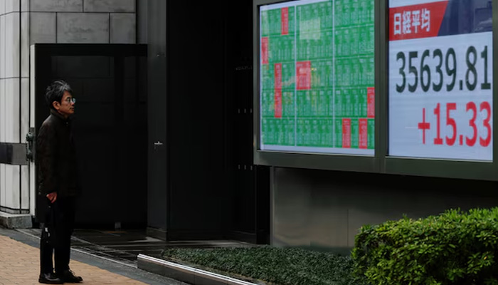 A man looks at a stock quotation board showing Nikkei share average outside a brokerage in Tokyo, Japan April 2, 2025. — Reuters