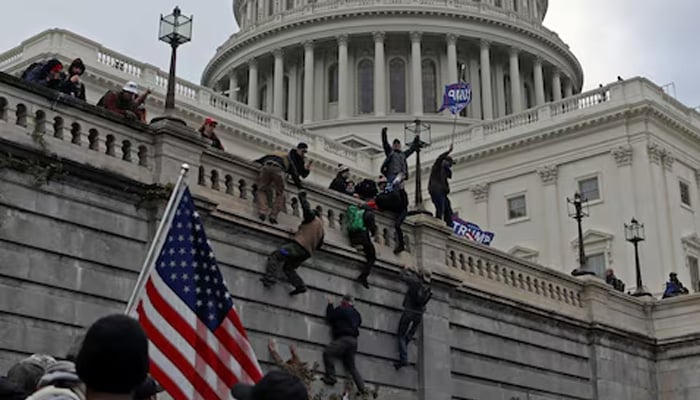 Supporters of US President Donald Trump climb a wall during a protest against the certification of the 2020 presidential election results by the Congress, at the Capitol in Washington, January 6, 2021. — Reuters