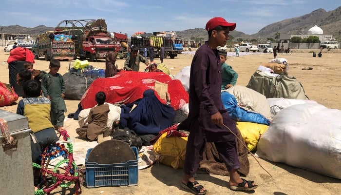Afghan nationals with their belongings gather as they head back to Afghanistan via the Torkham border crossing on April 7, 2025. — Reuters