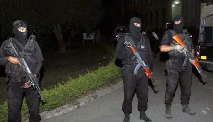 Masked law-enforcers are seen standing alert in Quetta in this undated image.  — APP/File