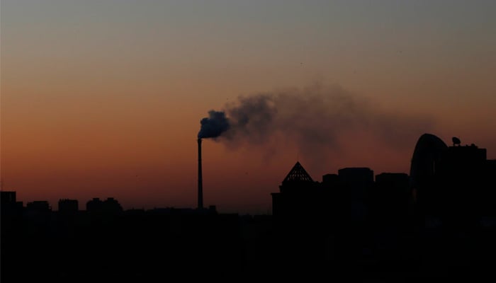 Smoke rises from a chimney of a cogeneration plant in Beijing November 25, 2013. — Reuters