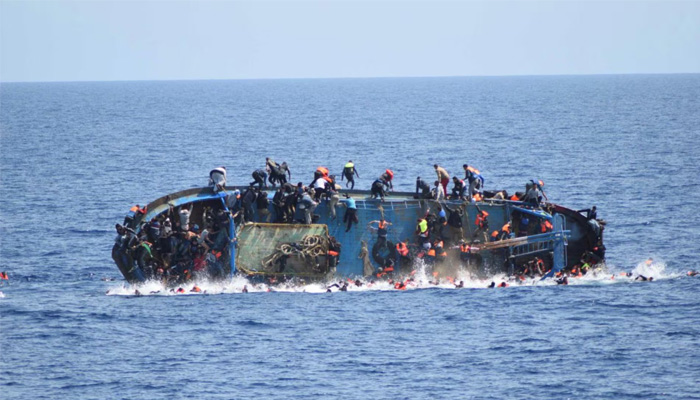 A boat overloaded with migrants is captured while capsizing in the deep sea. — Reuters/File
