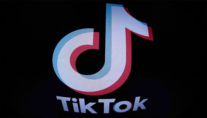 The logo of video-sharing site TikTok is seen on screen with dark background. — AFP/File