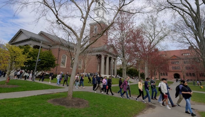 Students walk on the campus of Harvard University in Cambridge, Massachusetts, US, April 15, 2025.