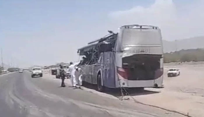 The damaged bus parked at the side of the road after getting involved in an accident. — Geo News