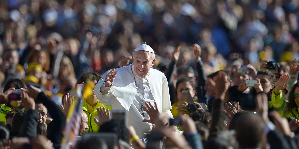 Pope Francis salutes the crowd as he arrives for his general audience in St Peters square at the Vatican on November 6, 2013. — AFP