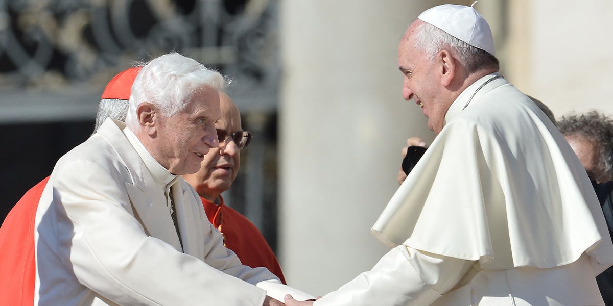 Pope emeritus Benedict XVI (L) speaks with Pope Francis during a papal mass for elderly people at St Peters square at the Vatican on September 28, 2014. — AFP