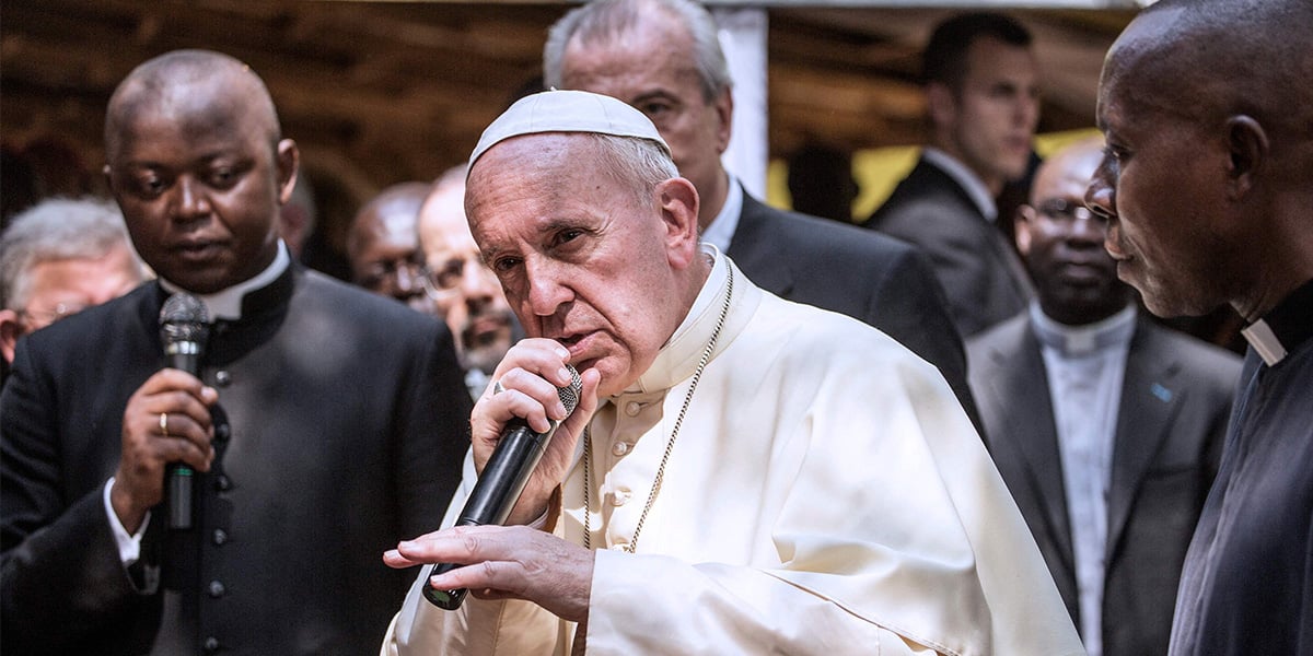 Pope Francis gestures as he gives his blessing during a visit to an internally displaced people camp at St. Saviour parish in Bangui on November 29, 2015. — AFP