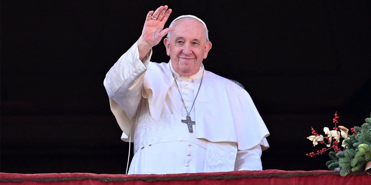 Pope Francis waves to the crowd as he appears at the balcony to deliver his Christmas Urbi et Orbi blessing in St. Peters Square at The Vatican on December 25, 2022. — AFP